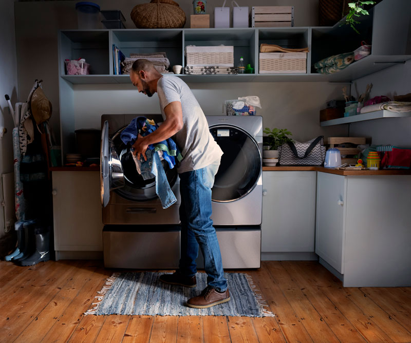Whirlpool-brand-man-loading-dryer Whirlpool-brand-man-loading-dryer