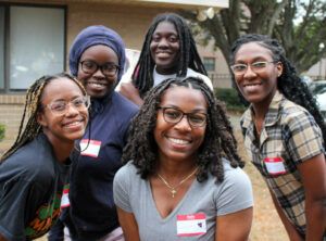 Five smiling young women, students at FEMU pose for their photo