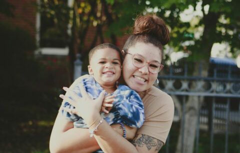 Habitat Homeowner Maya holding her small son