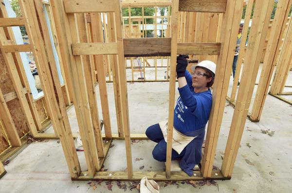 Woman building a Habitat home