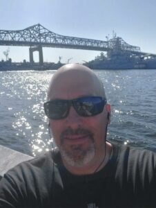 Fall River employee taking exercise selfie in front of water and the bridge