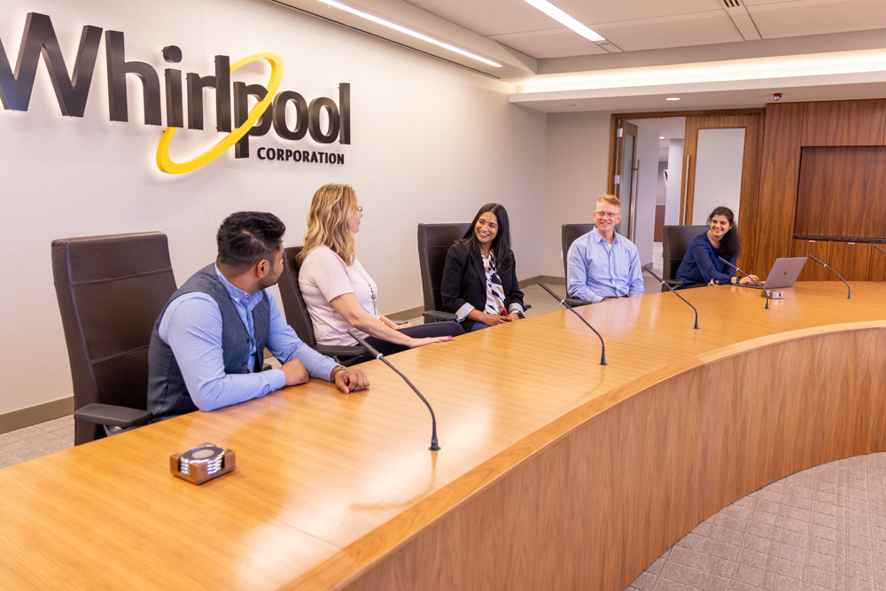 5 Whirlpool employees talking in a conference room