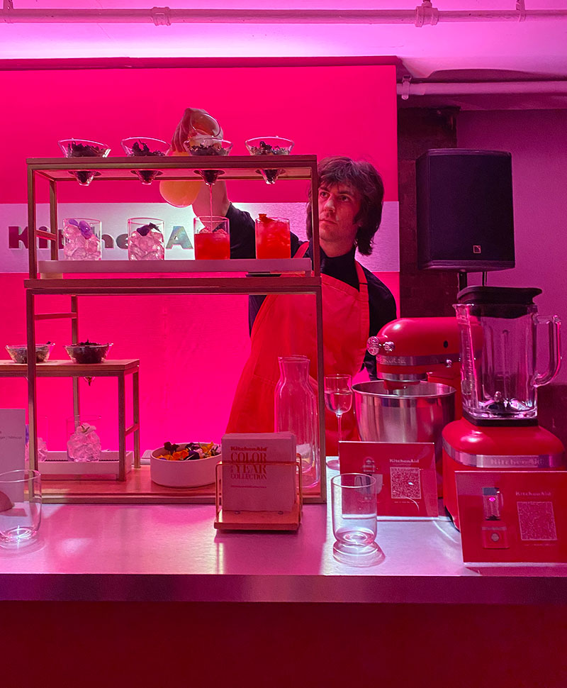 pink set with man pouring pink drinks for KitchenAid color of the year event