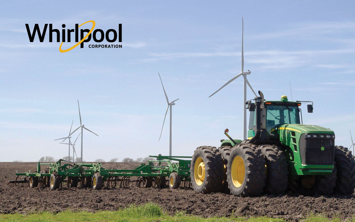 Tractor breaks ground with wind turbines in background, part of Whirlpool Corp second VPPA at Limestone Windfarm