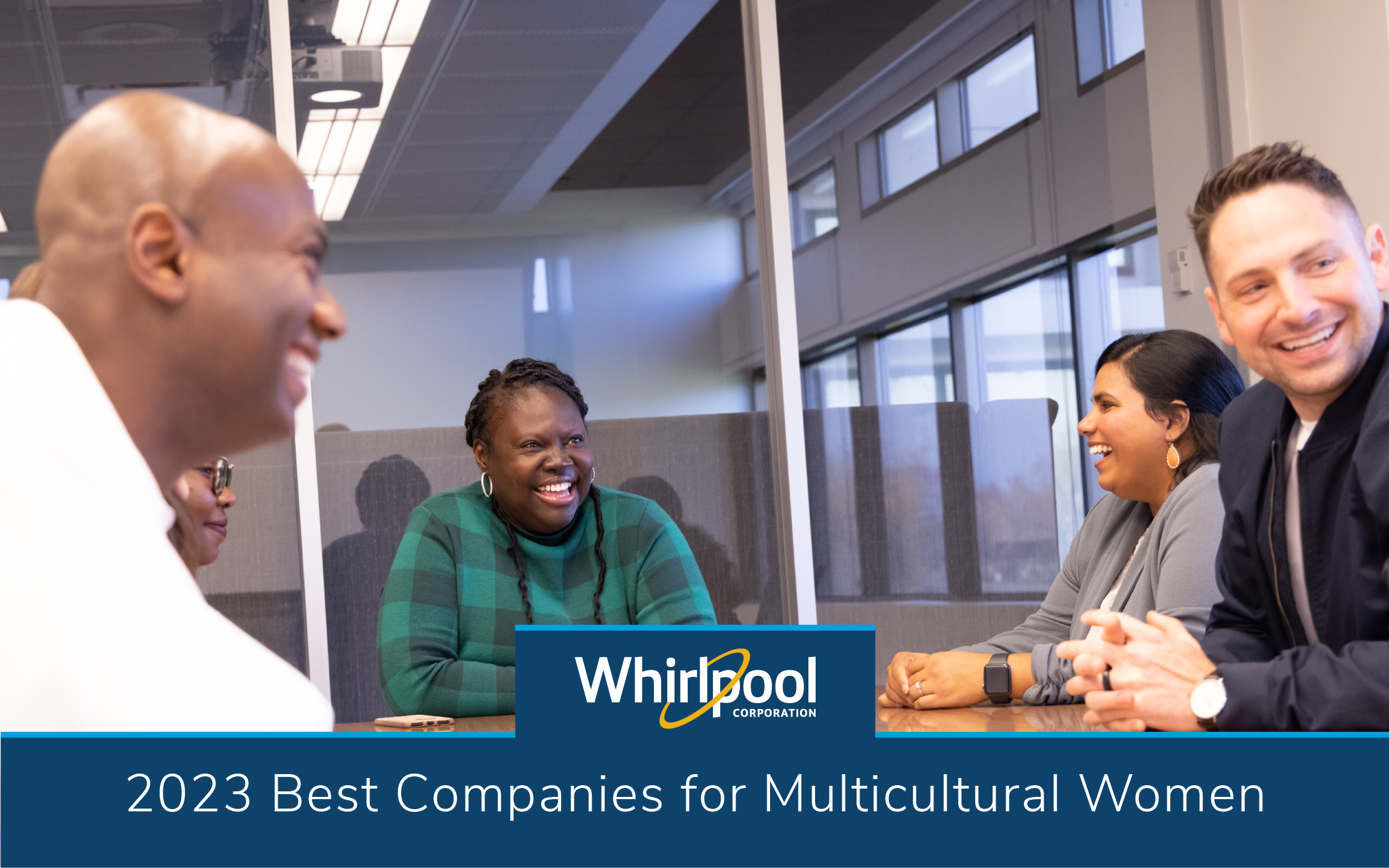 Group of multicultural employees in a conference room laughing and having fun